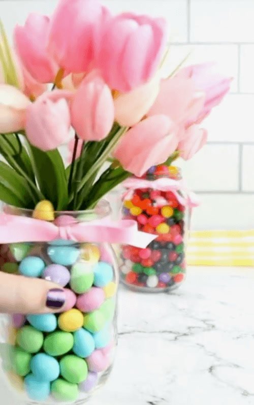 Candy eggs in mason jars filled with fake flowers
