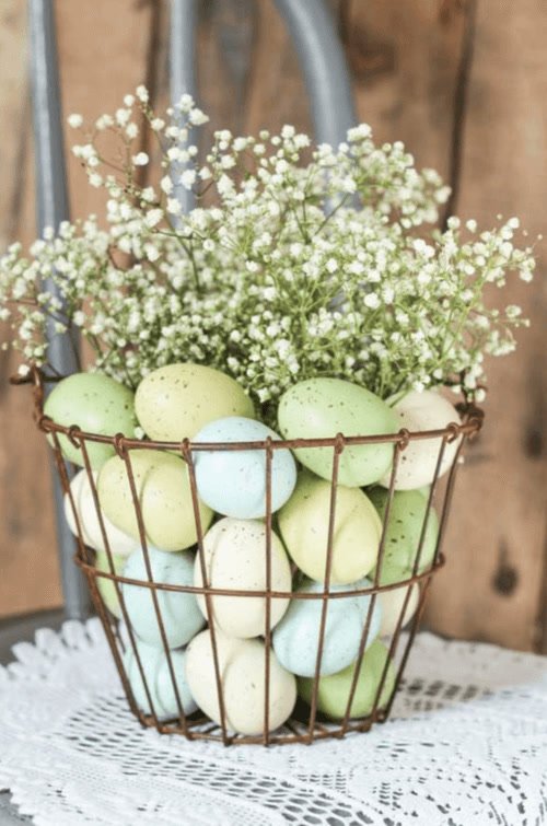 Colored eggs in old-fashioned metal baskets