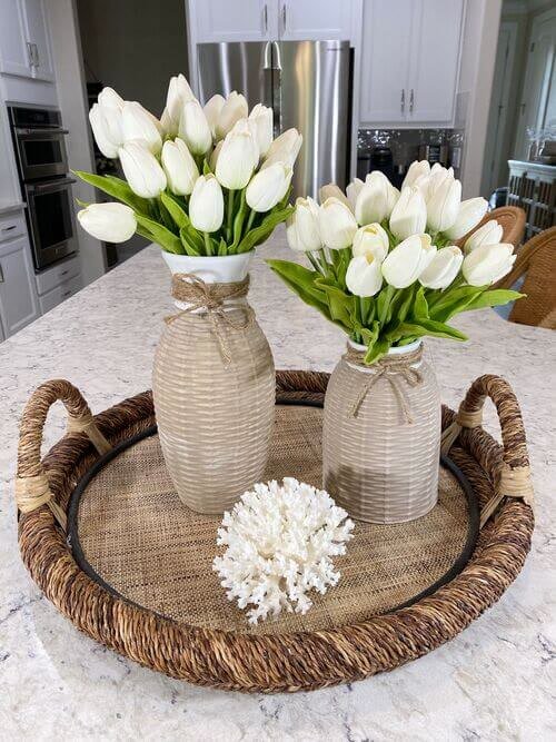 White tulips in jars wrapped with twine