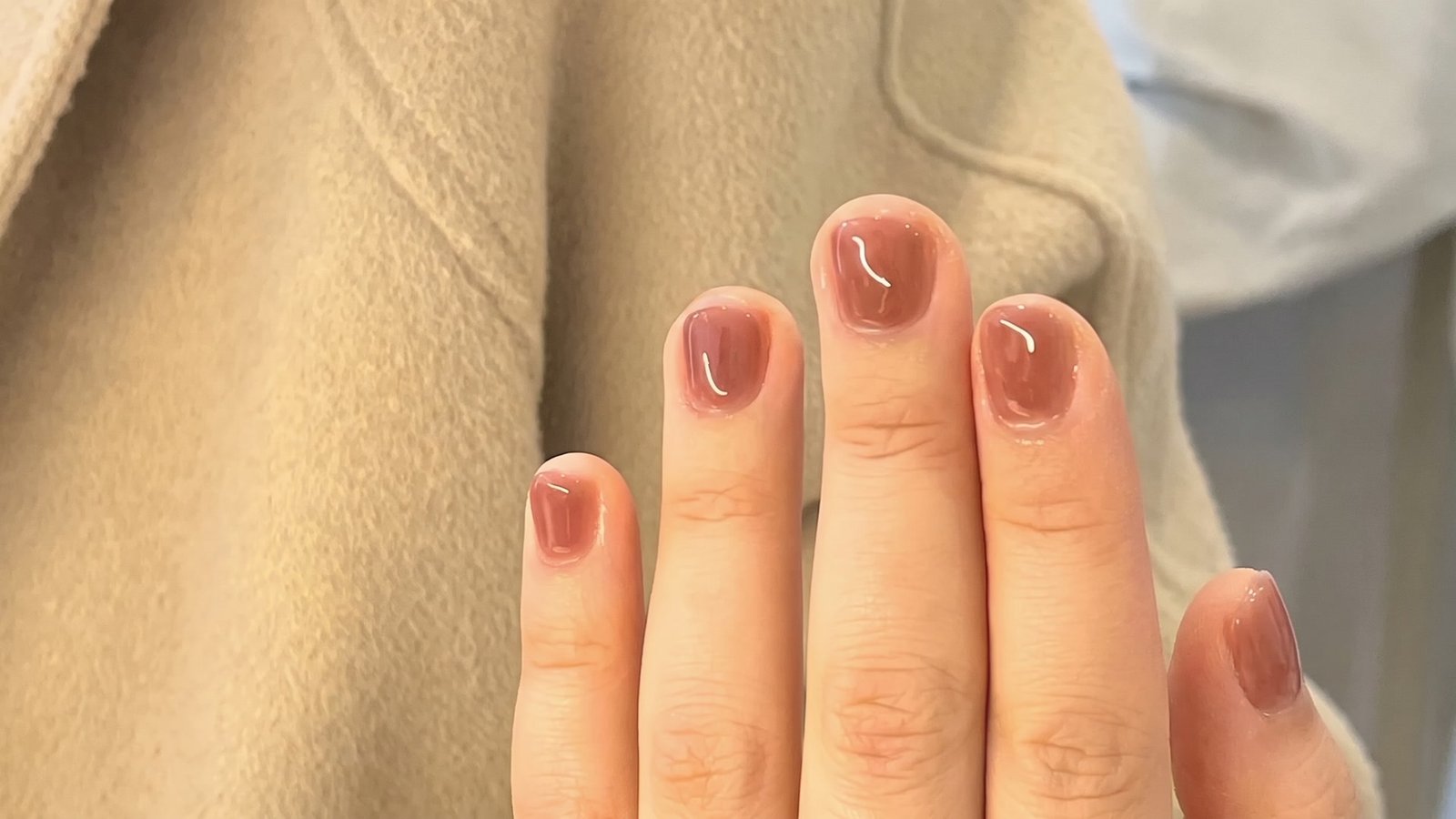 Short rounded nails with sheer glossy blush jelly polish